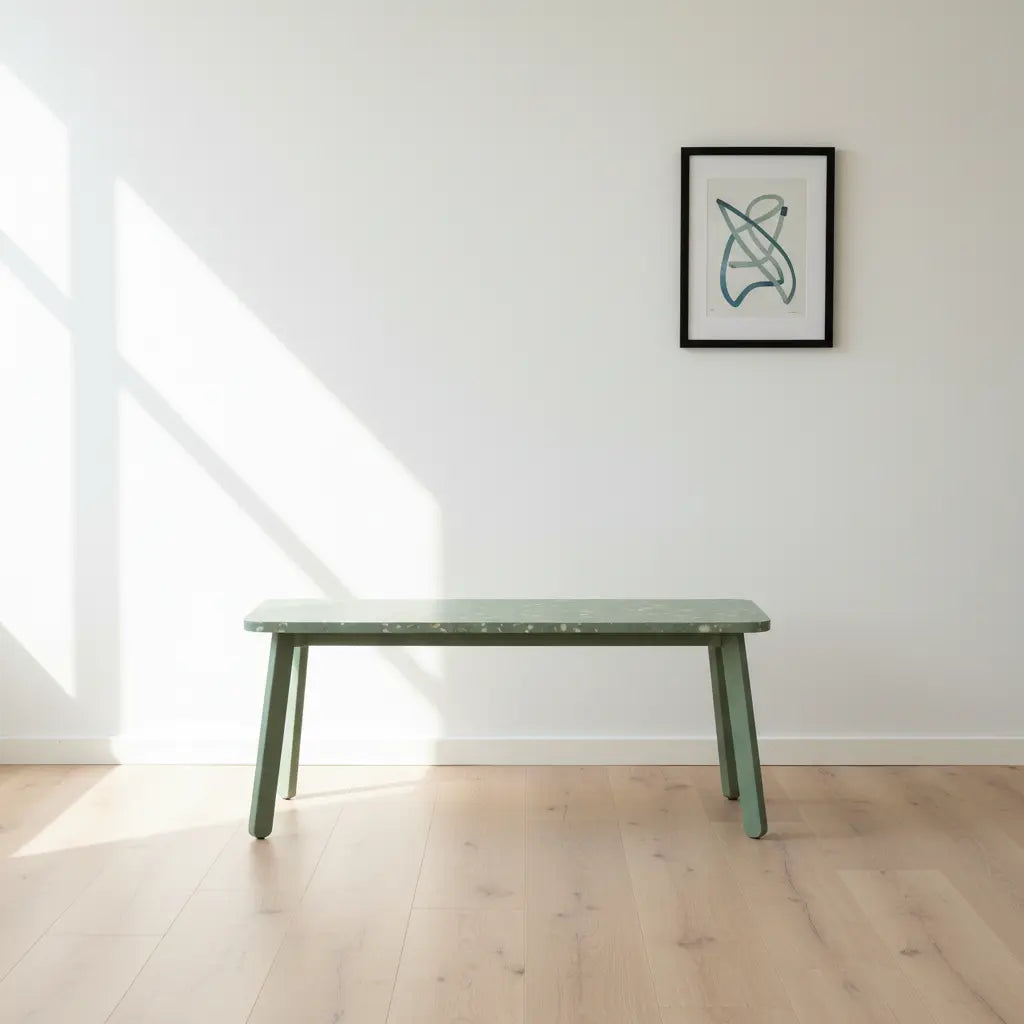 Eco-friendly green polymer bench with recycled HDPE panel top in a bright, minimalist white-walled room